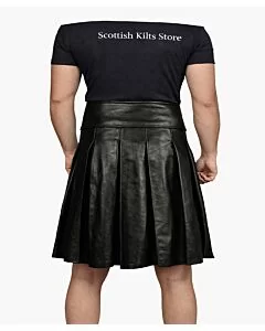 Black leather gothic utility kilt with adjustable straps and metal buckles, front view showing rugged design and deep utility pockets
